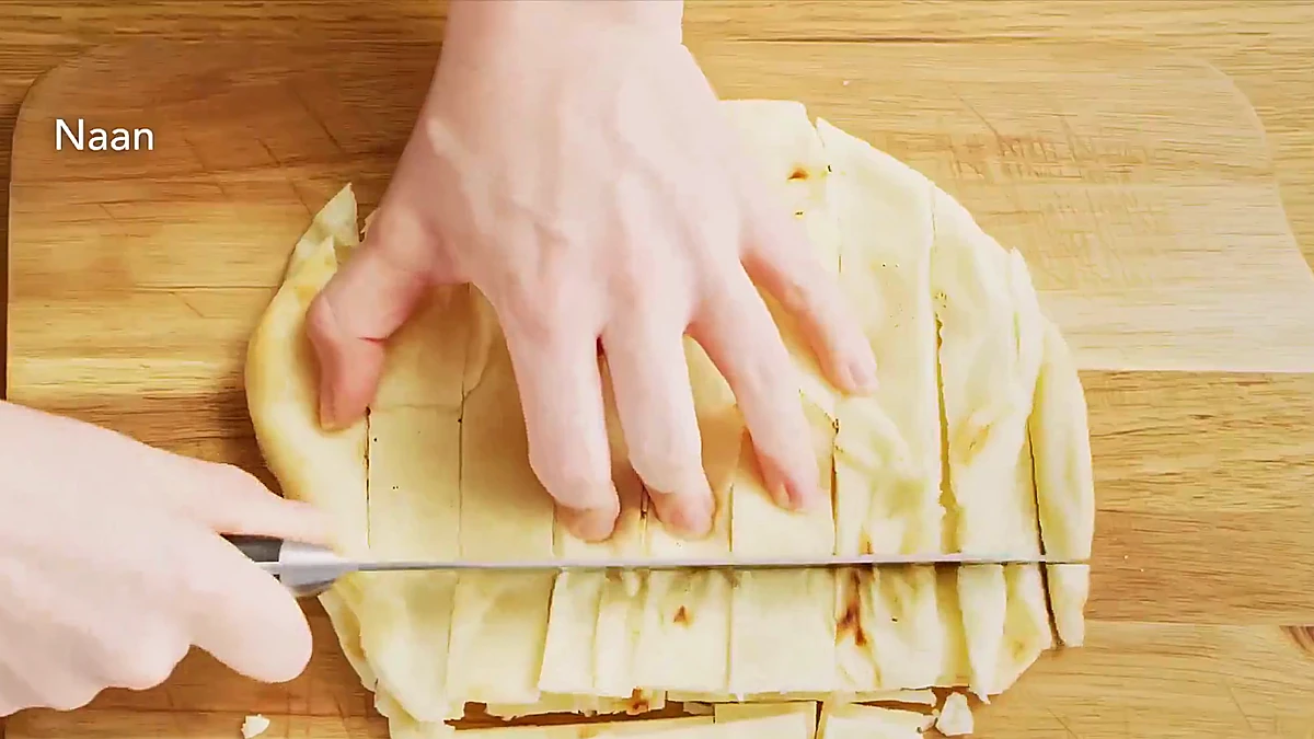 Warm naan cut into bite size pieces