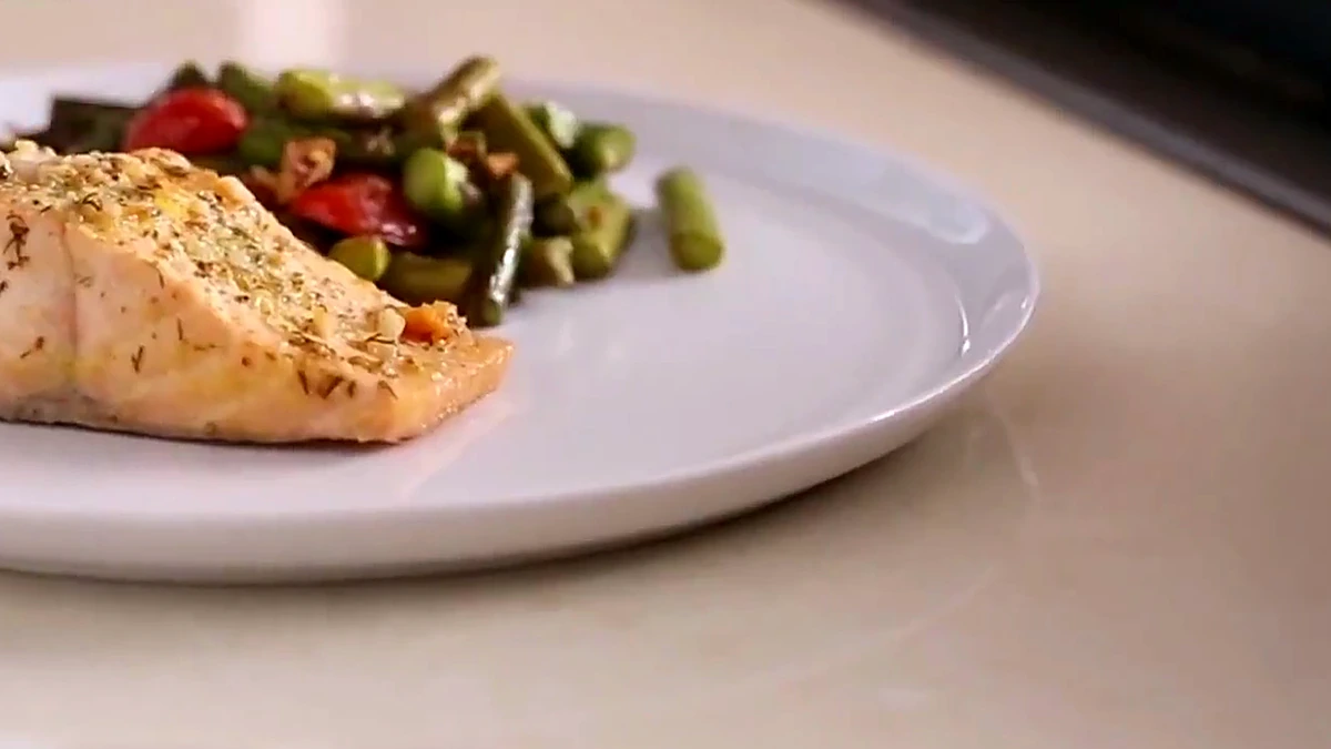 Finished salmon with asparagus almond salad from a side angle