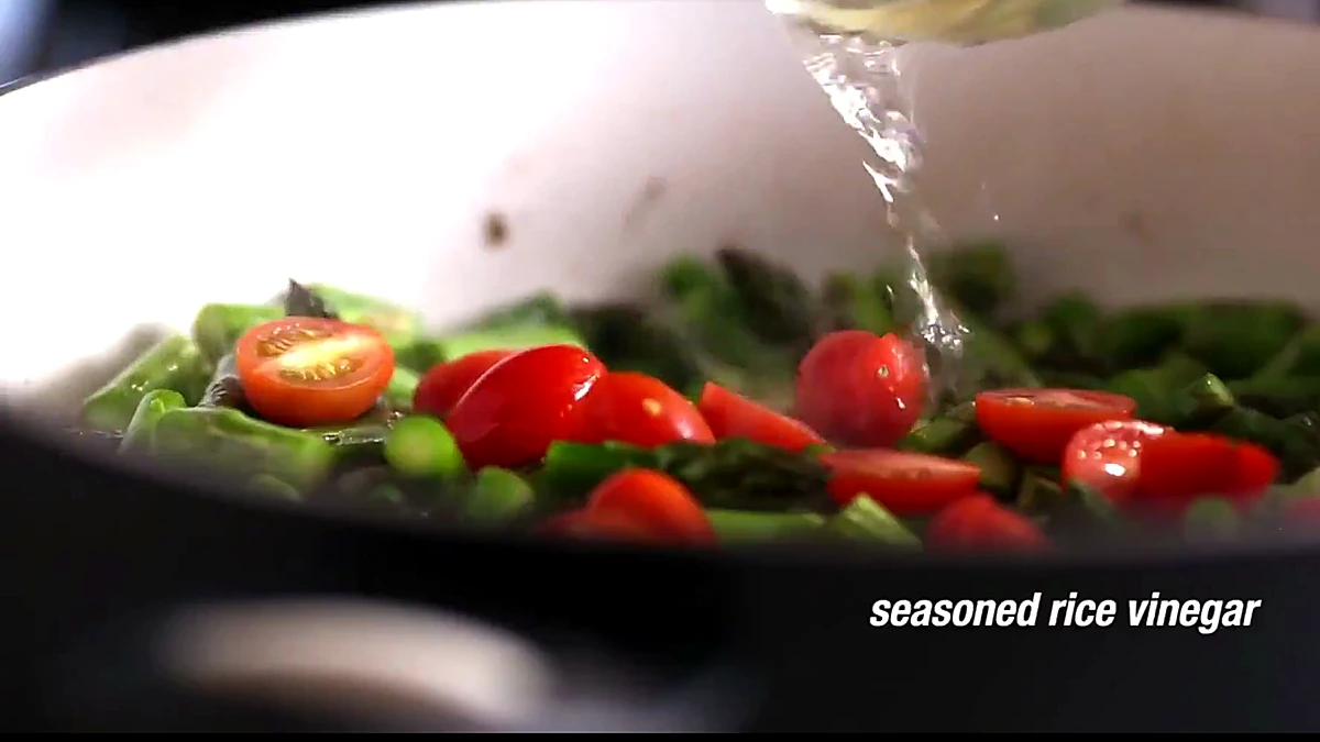 Seasoned rice vinegar poured over asparagus and tomatoes