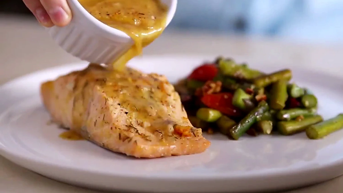 Orange Dijon sauce spooned over salmon