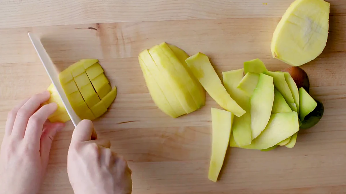Green apple being chopped for tropical shrimp salad