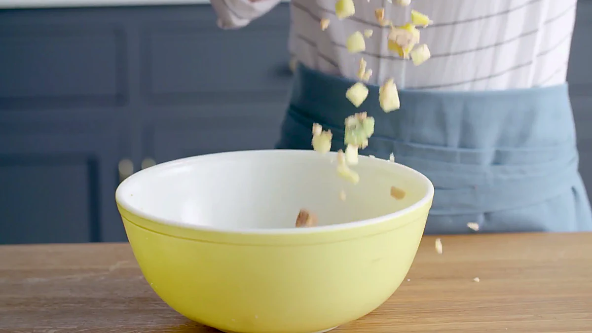 Fruit being added to a bowl