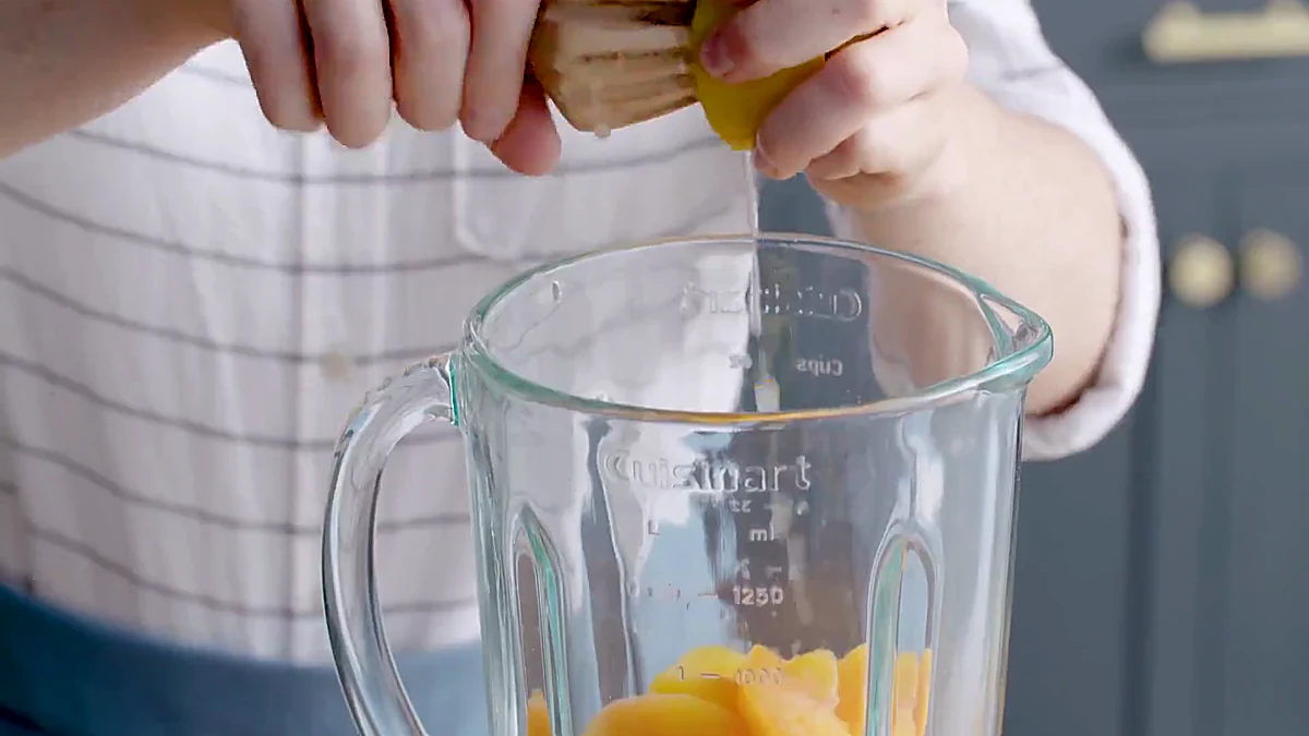 Lemon juice squeezed into peach slushy blender