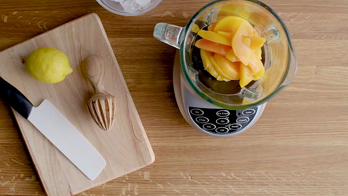Frozen peaches in a blender for peach slushy
