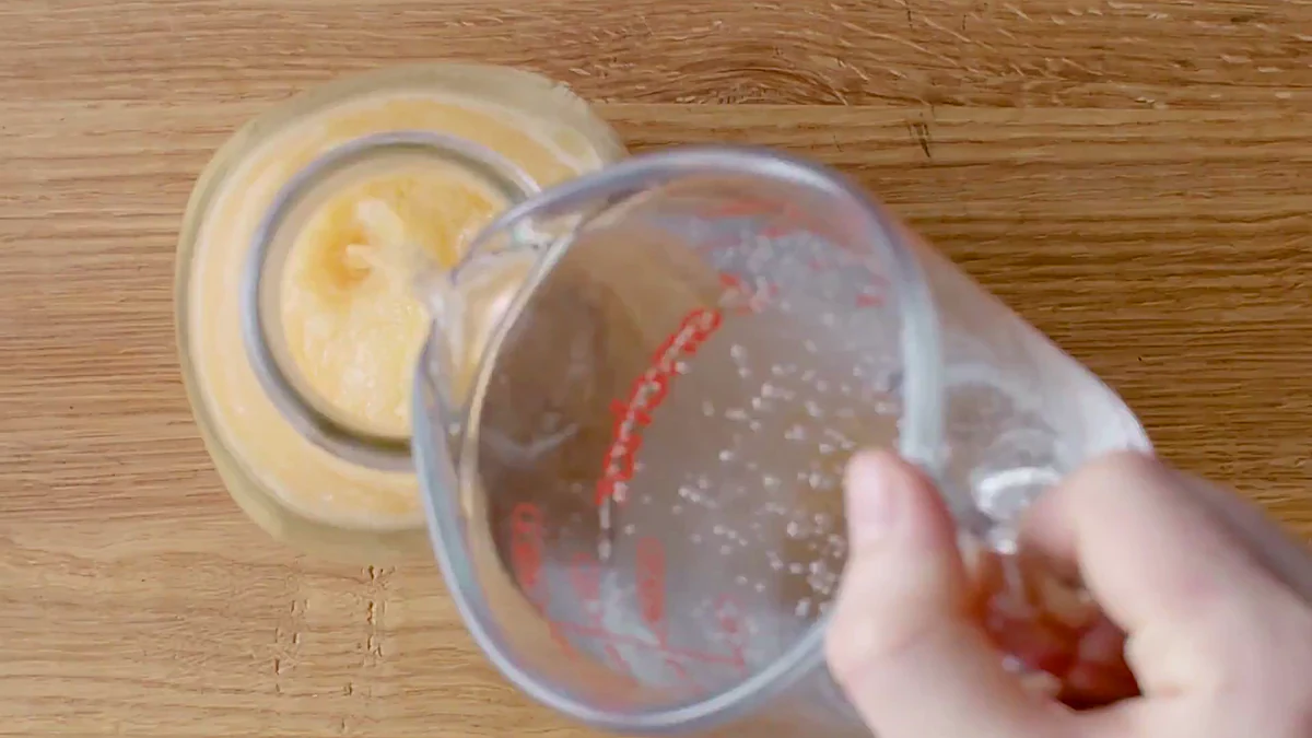 Sparkling water poured into peach slushy