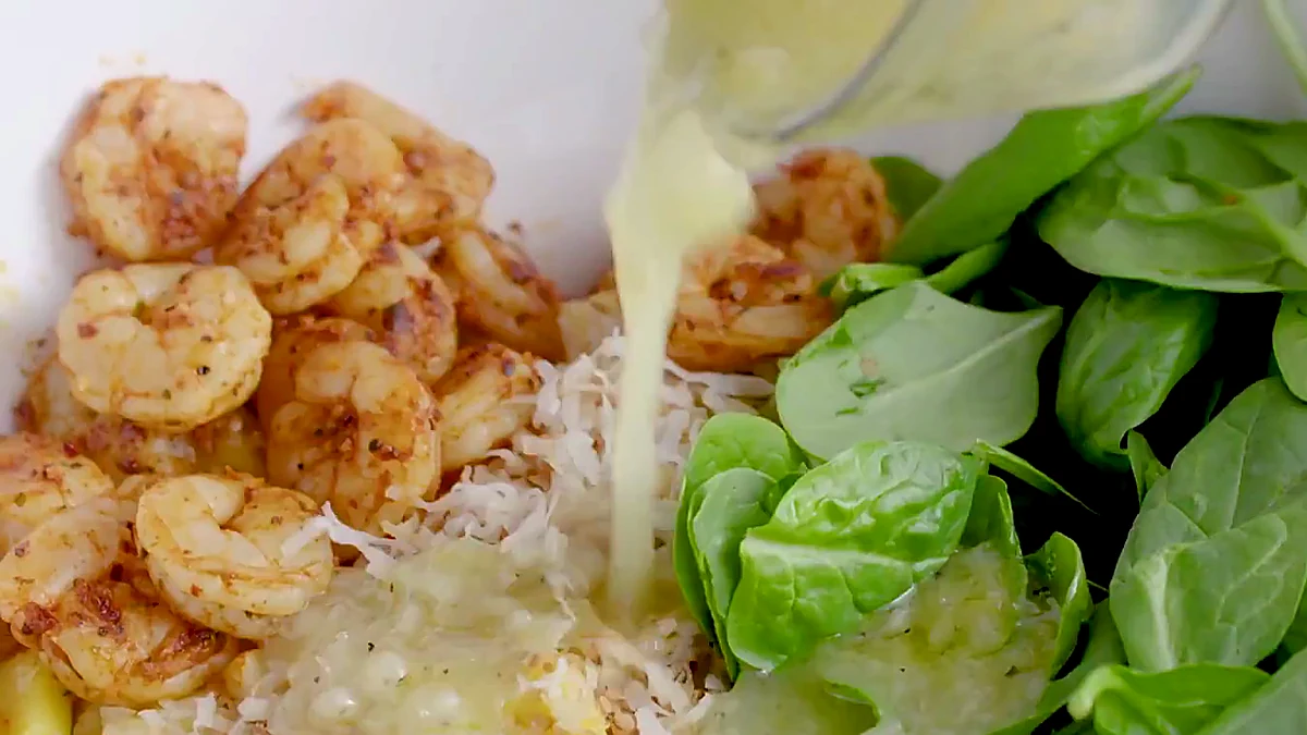 Lemon vinaigrette added to tropical shrimp salad