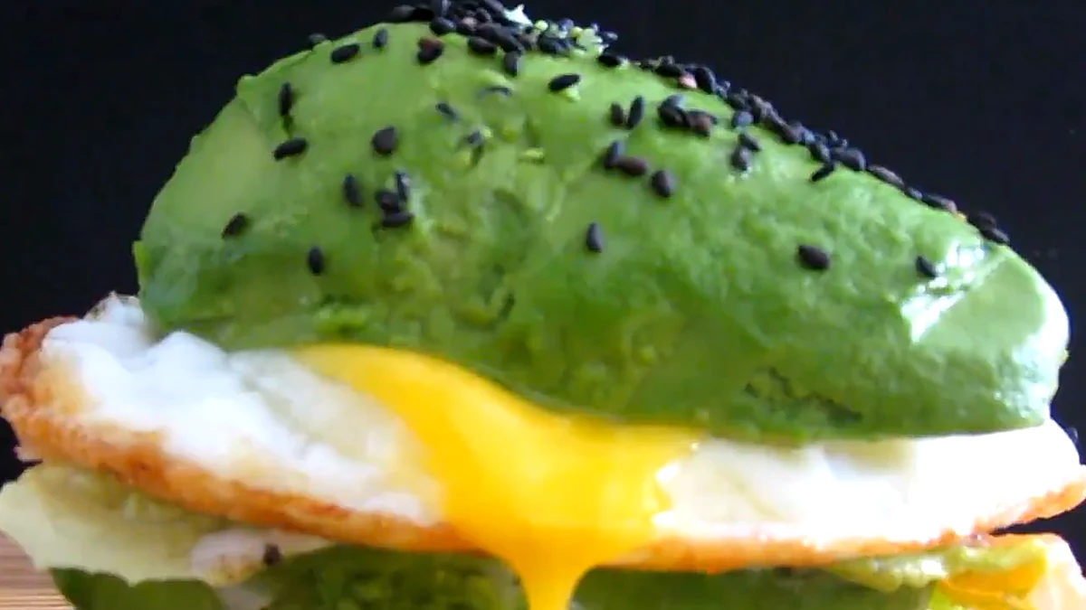 Close view of avocado burger with egg yolk