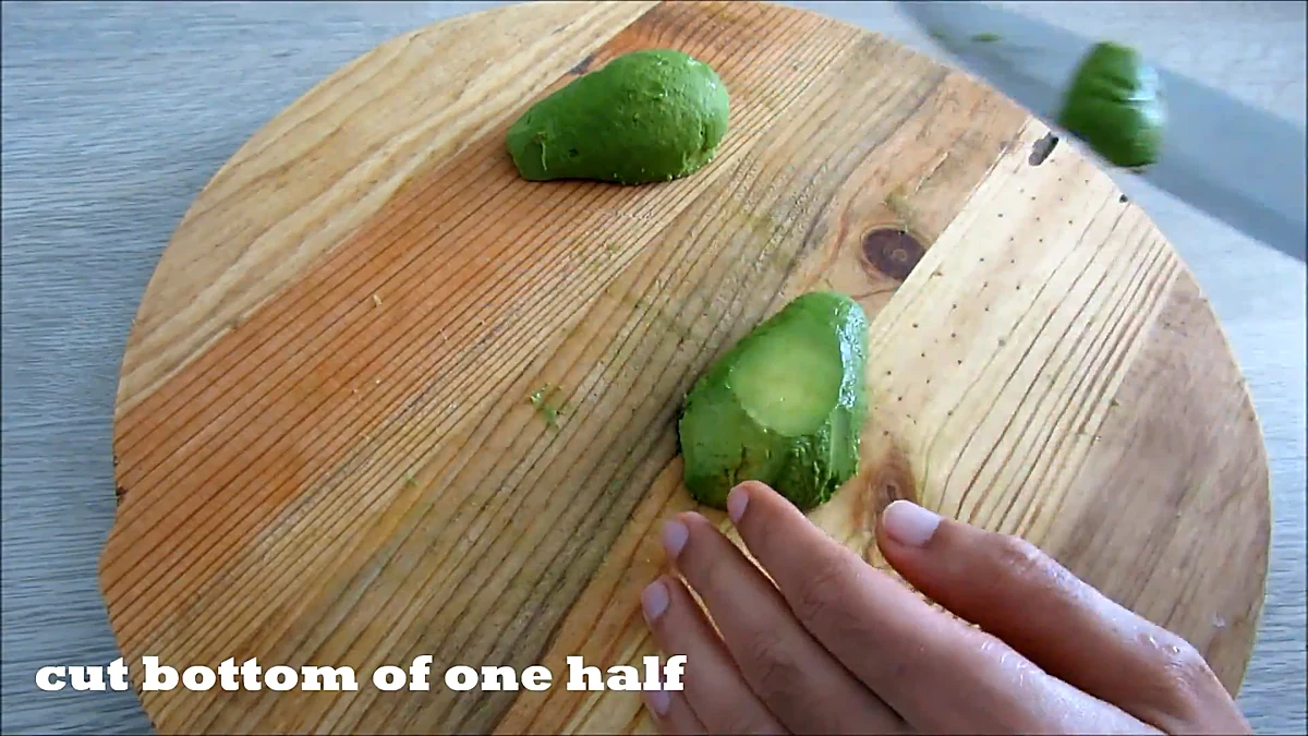 Bottom of one avocado half trimmed flat