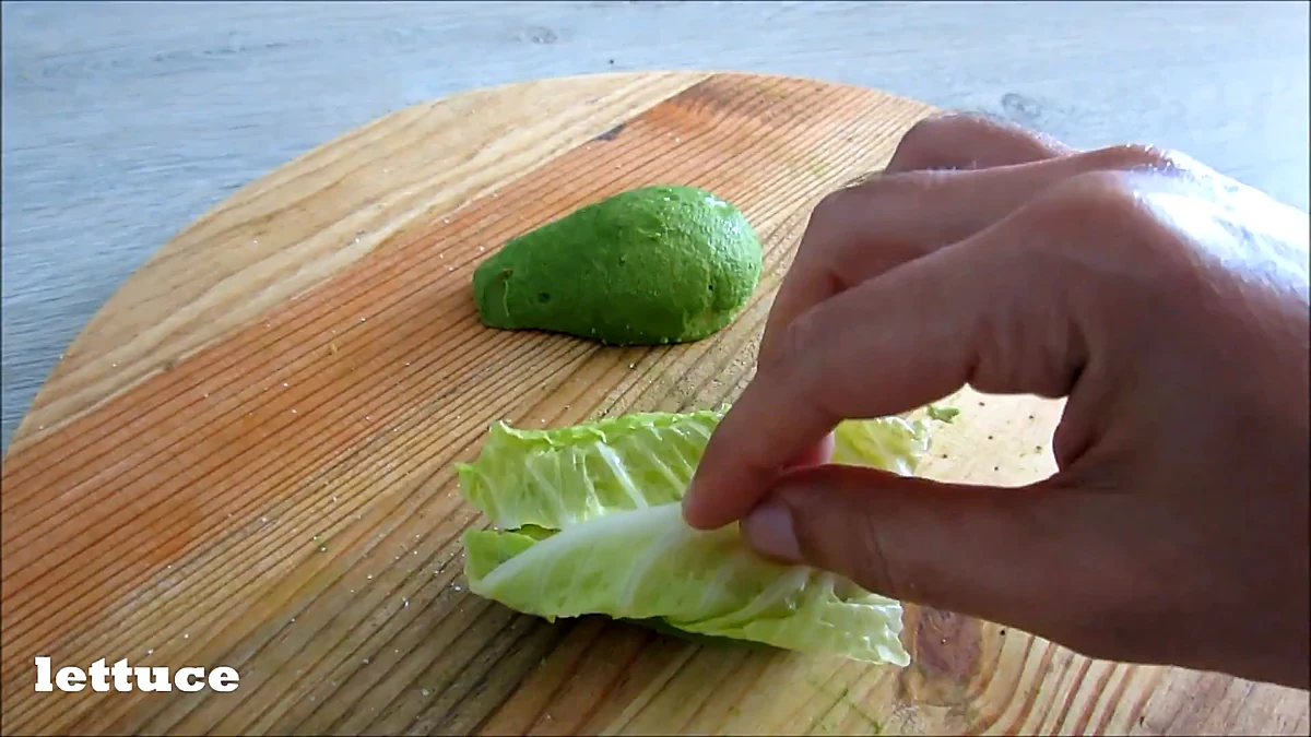 Lettuce placed on avocado burger base