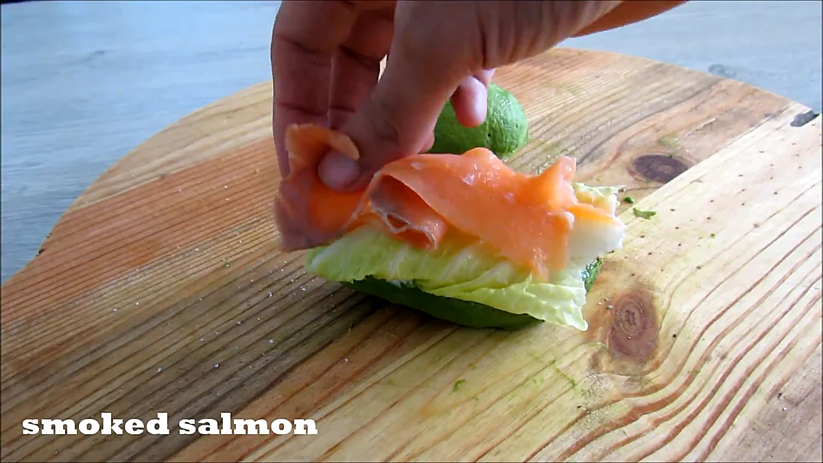 Smoked salmon layered over lettuce