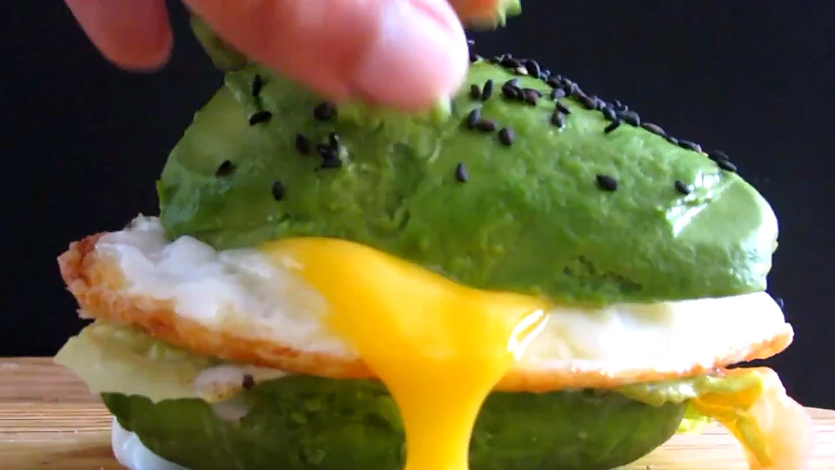 Finished avocado burger with runny egg yolk
