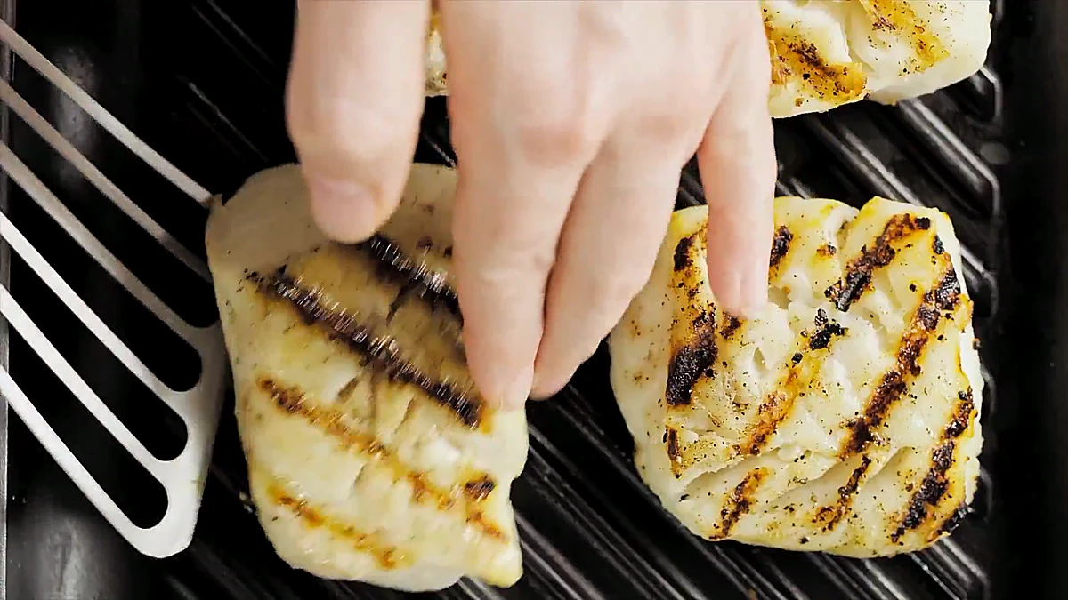 White fish fillets grilling with char lines