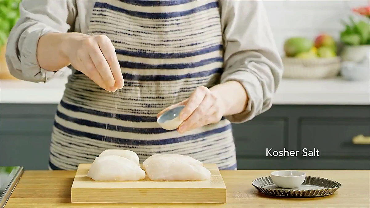 Kosher salt sprinkled over white fish fillets