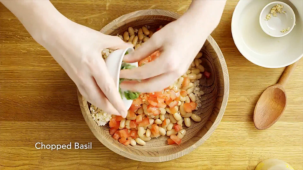 White beans, tomatoes, and chopped basil added to the rice