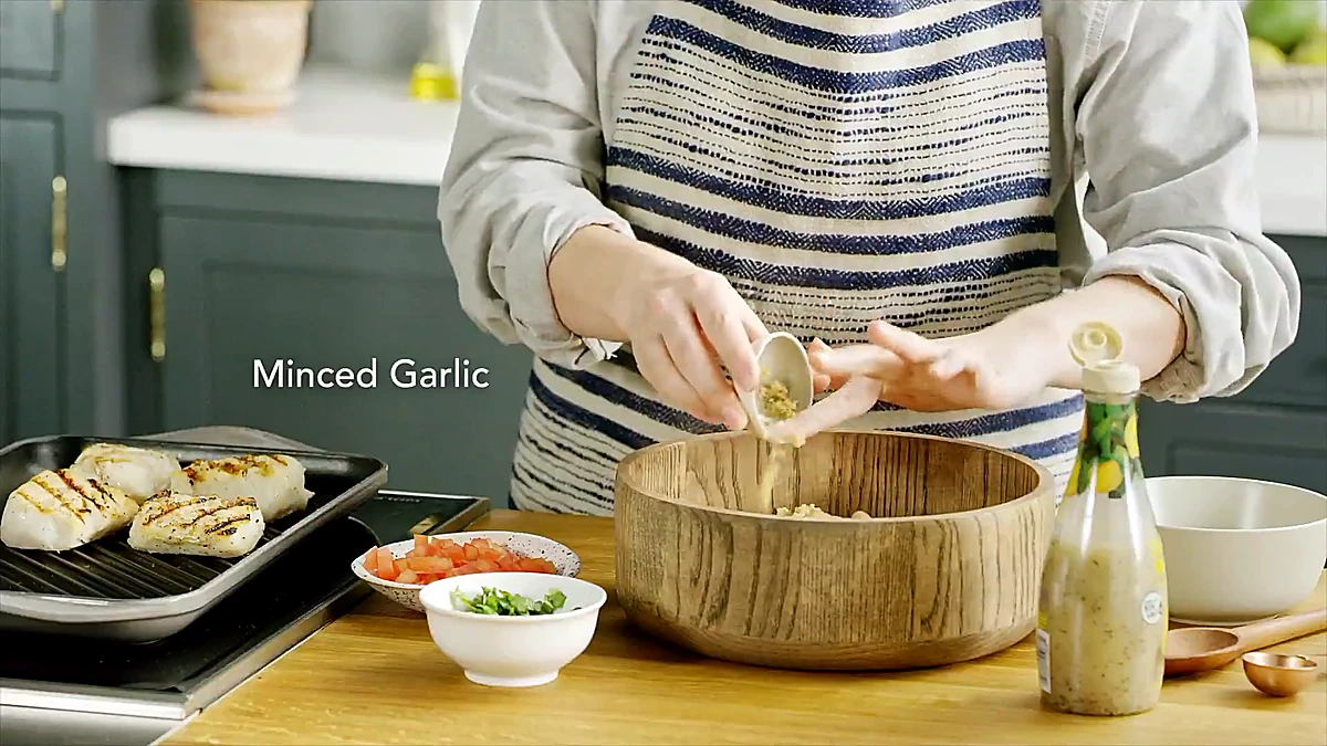 Minced garlic added to a bowl of cooked rice