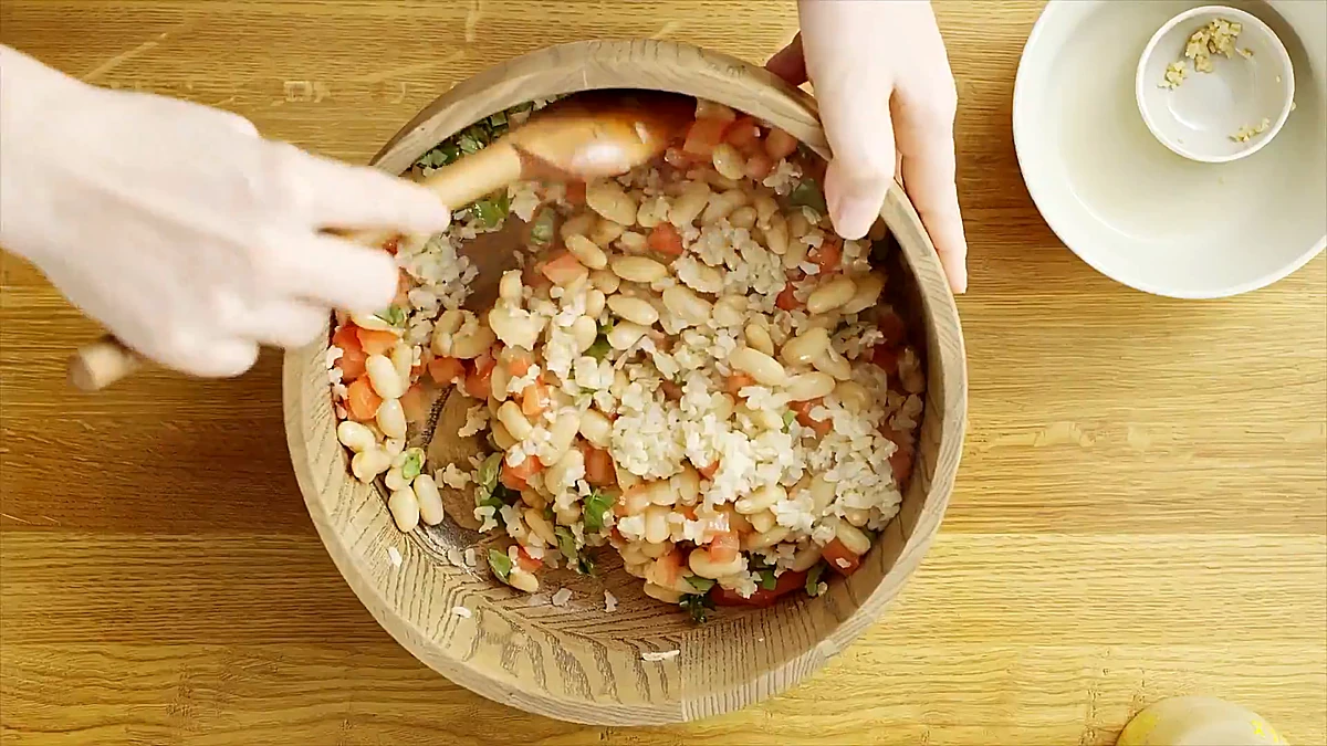 White bean and basil rice tossed together in a wooden bowl