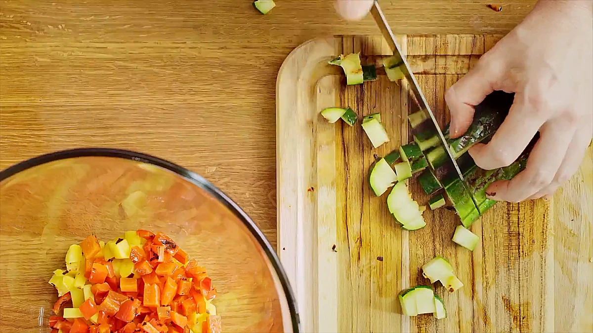 Grilled zucchini and peppers being chopped for the relish