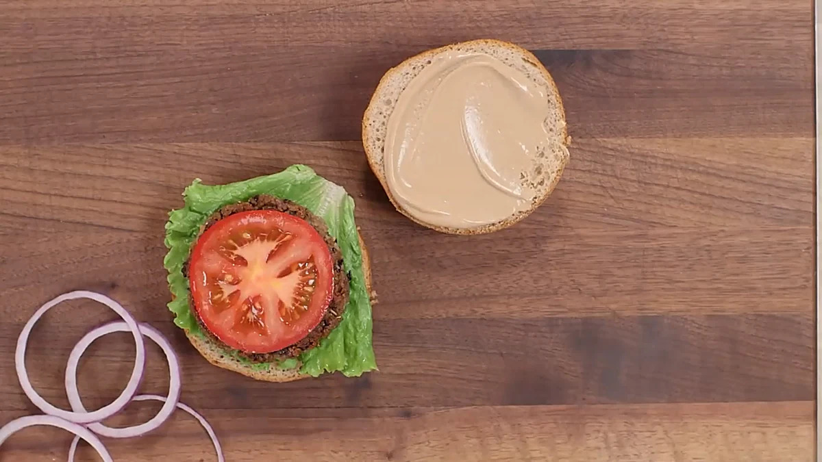 Open black bean burger with tomato and lettuce