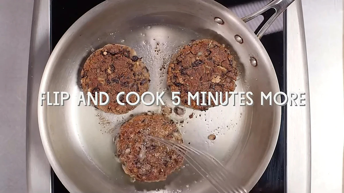 Black bean burger patties flipped in the pan