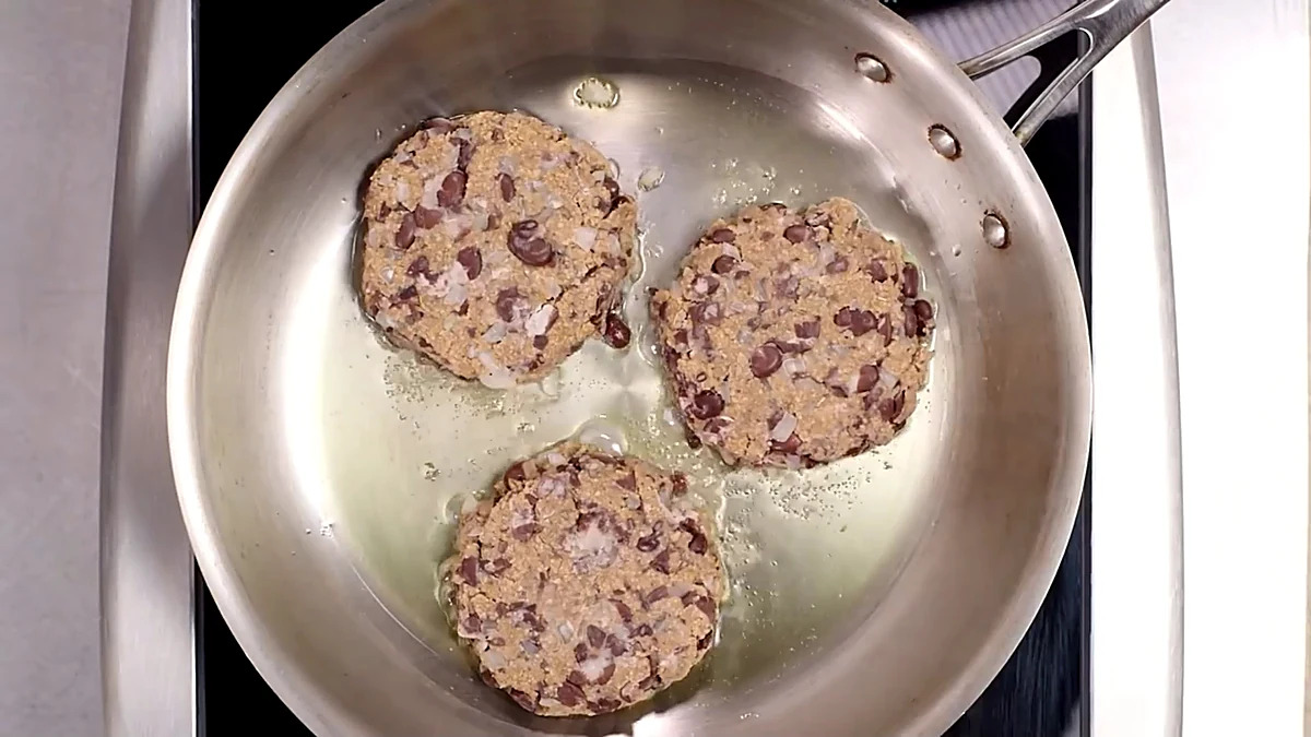 Black bean patties cooking in a skillet