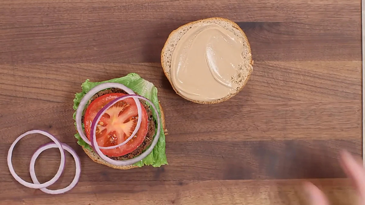 Tomato and red onion added to black bean burger