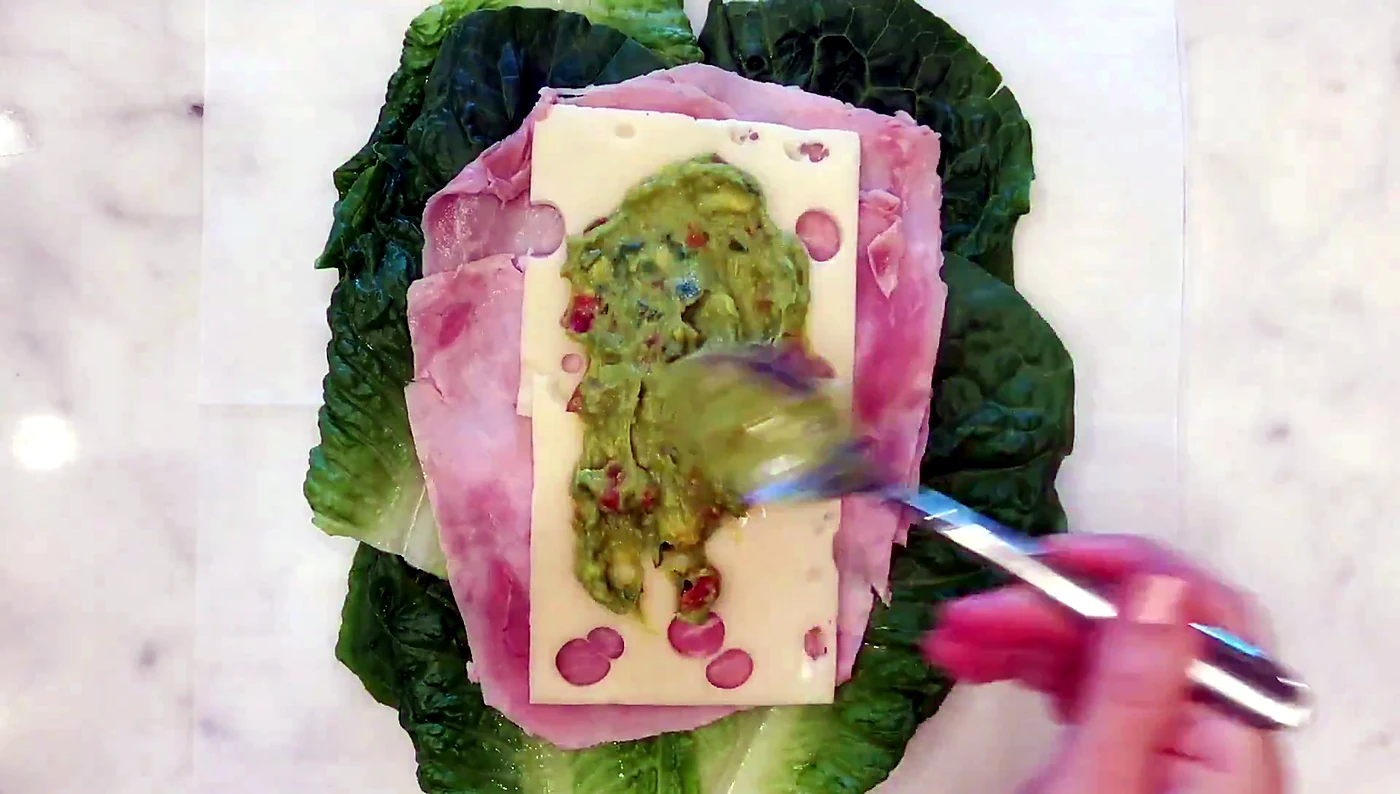 Avocado spread added over Swiss cheese