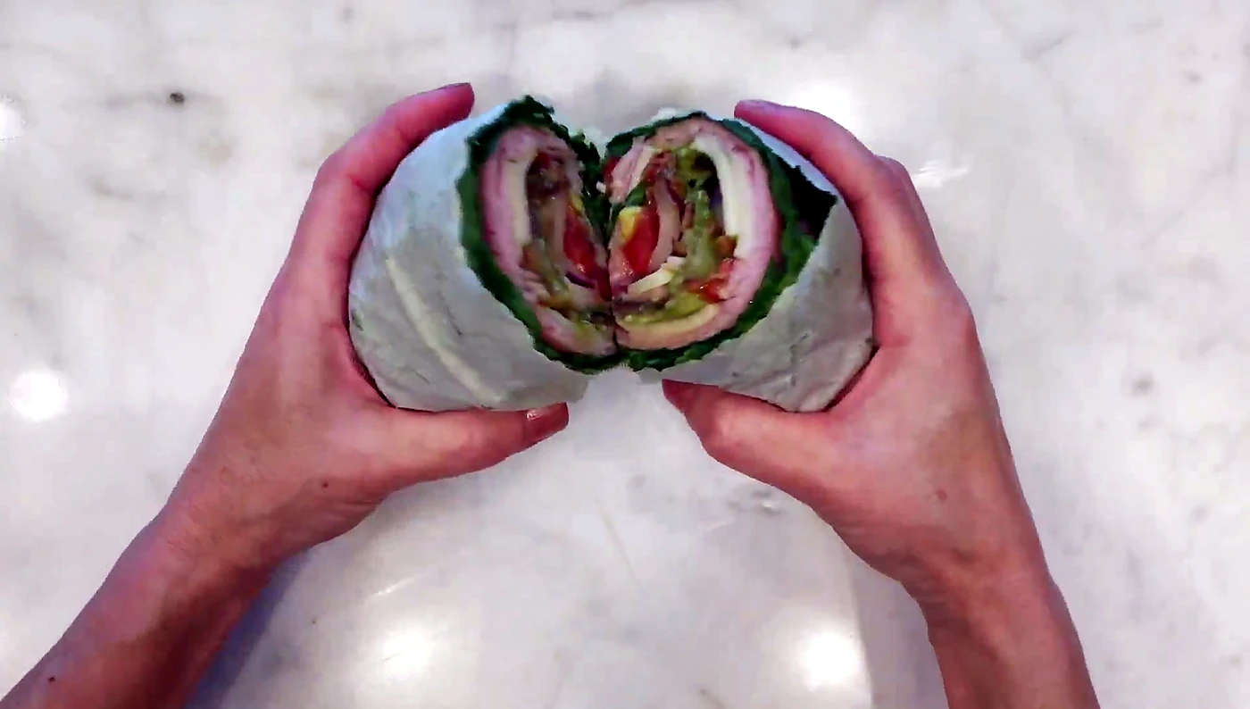 Cut lettuce wrap sandwich showing the layers