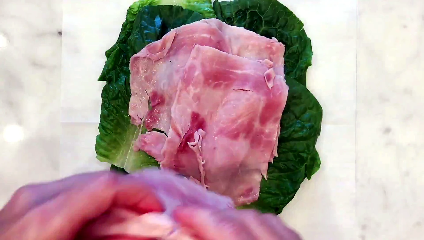 Deli turkey layered over lettuce