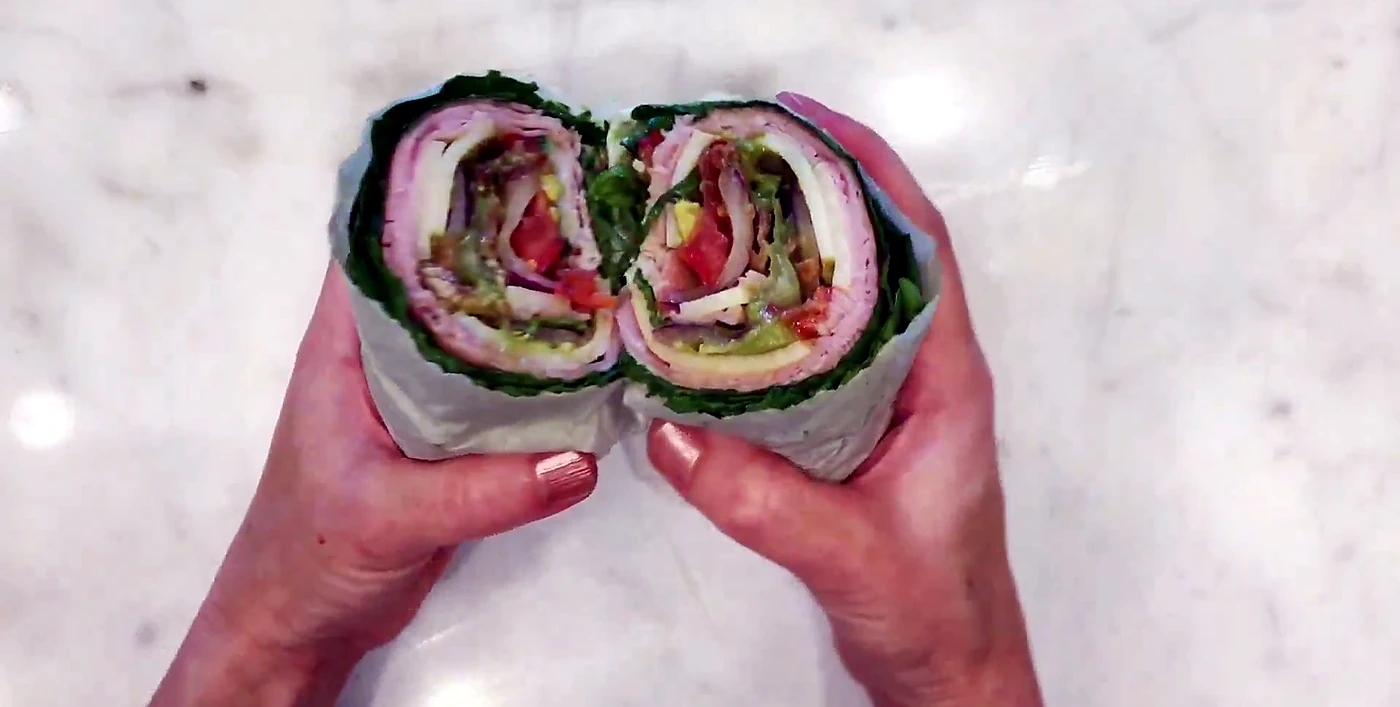 Wrapped lettuce sandwich halves held together