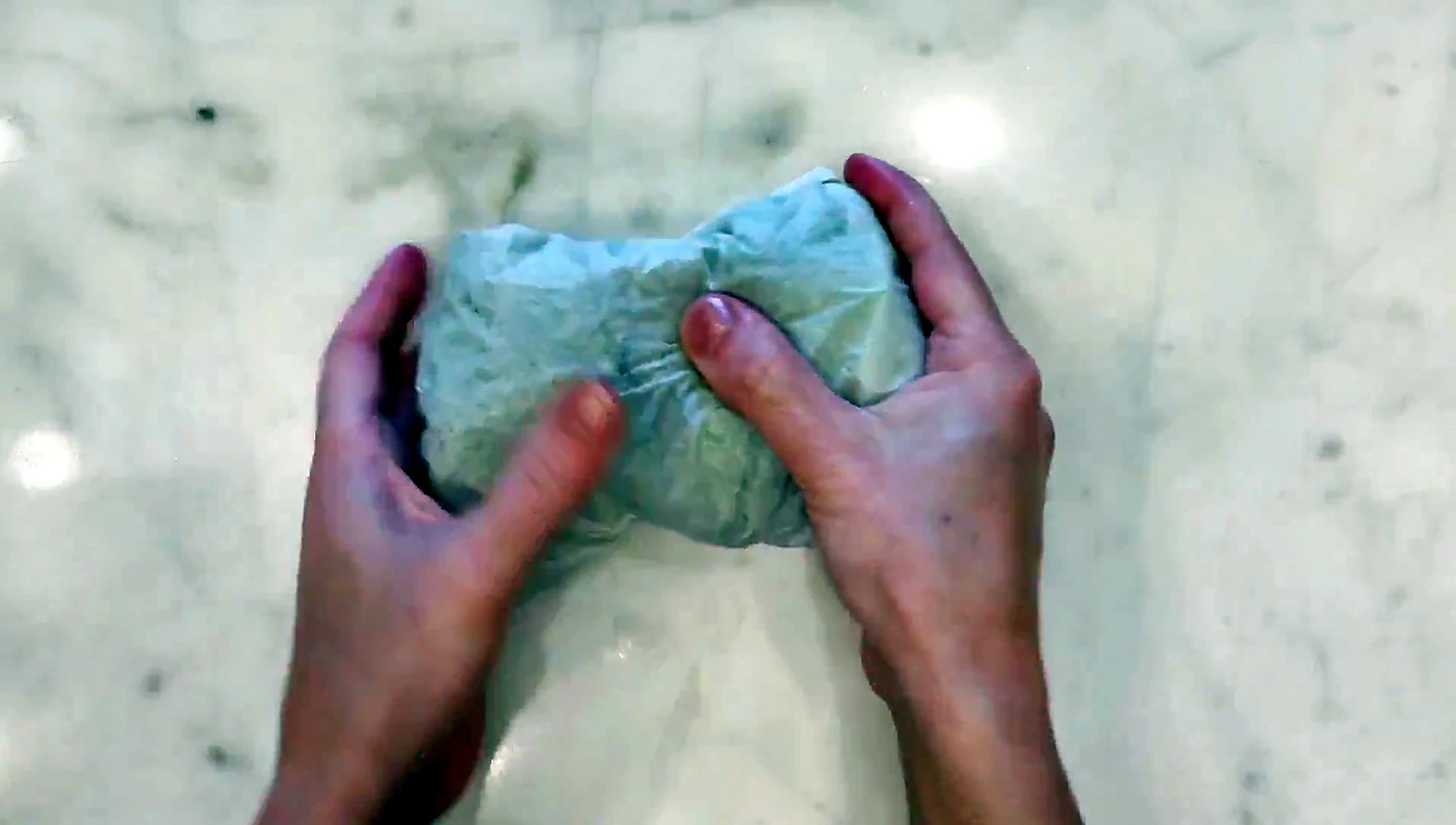 Lettuce wrap rolled tightly in parchment