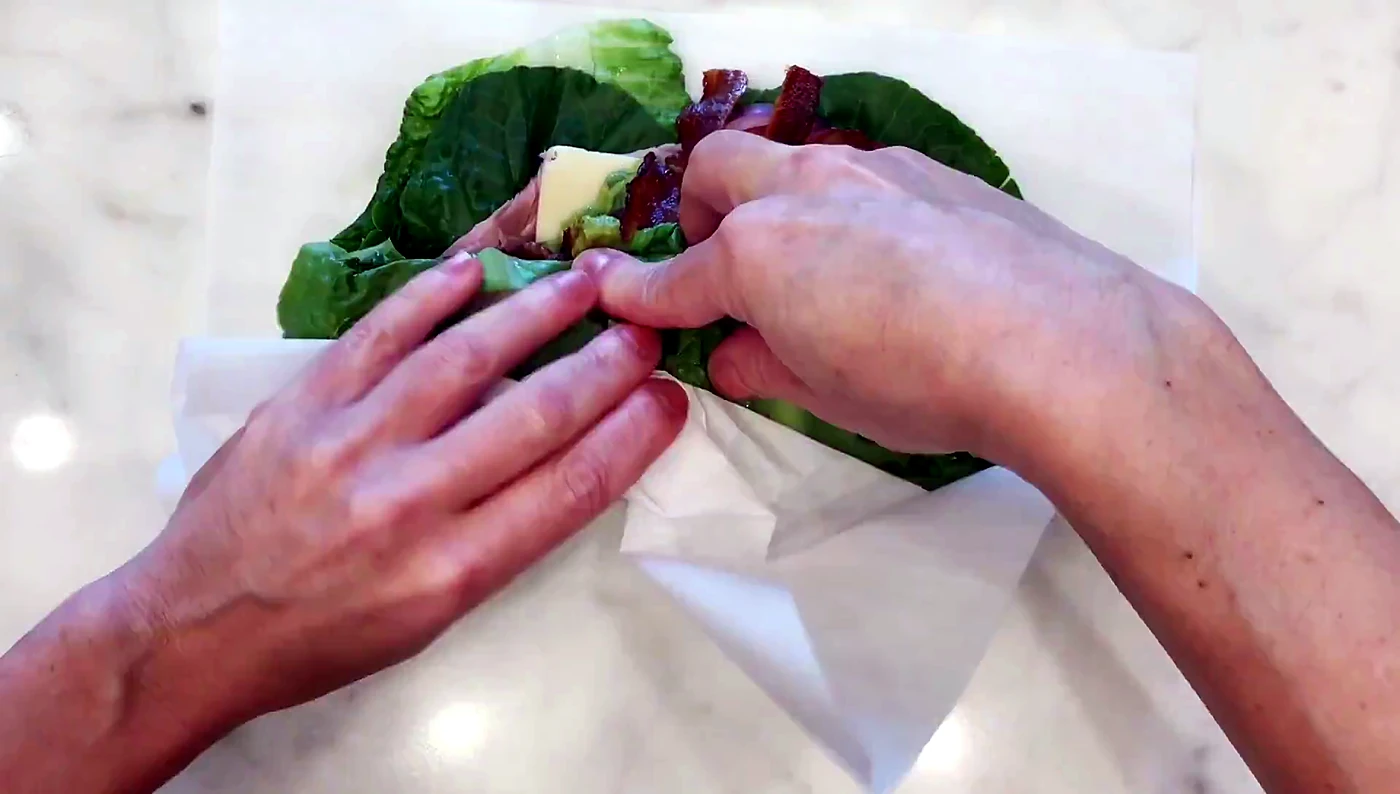 Sides of lettuce folded over sandwich filling