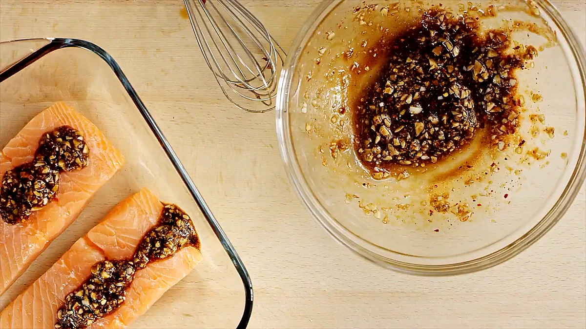 Salmon fillets coated with the citrus balsamic marinade in a glass dish