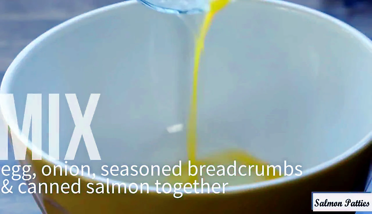Egg added to a mixing bowl for salmon patties