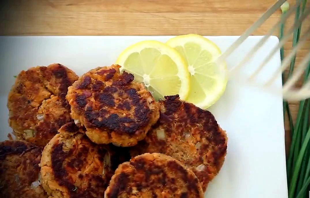 Overhead salmon patties stacked with lemon