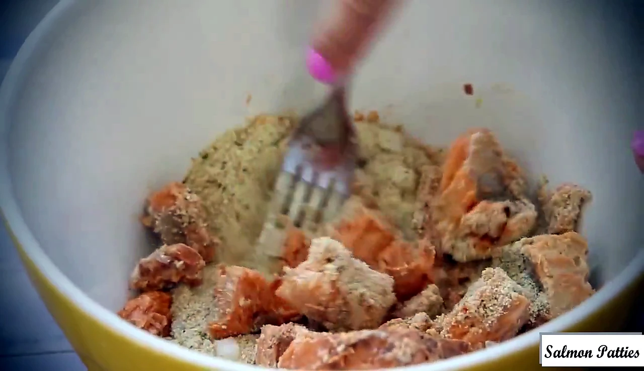Salmon patty mixture mixed with a fork