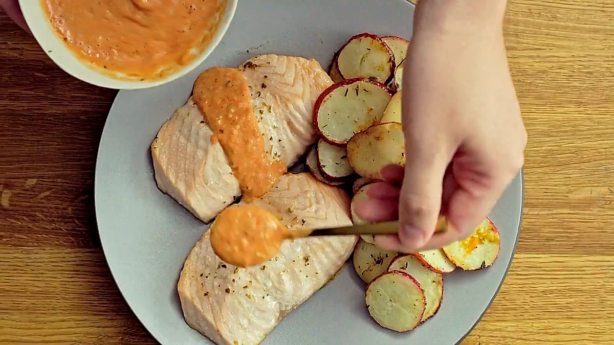 Overhead view of the salmon with tomato butter sauce and lemon potatoes