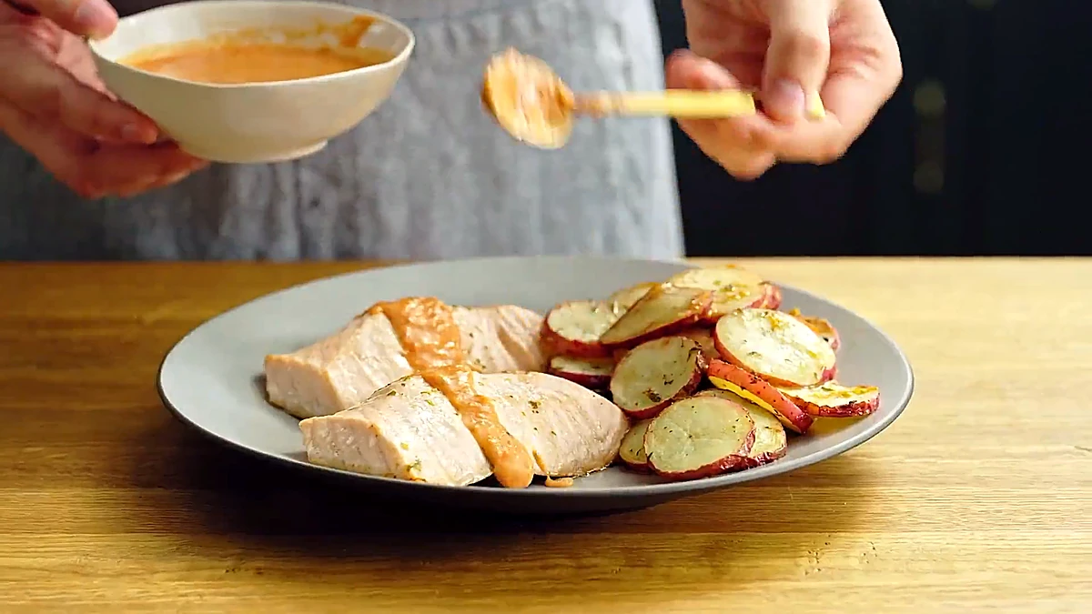 Tomato butter sauce spooned over the baked salmon