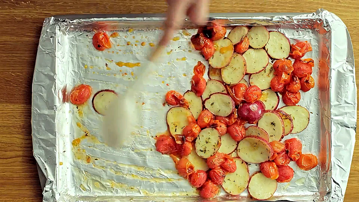 Roasted potatoes and blistered tomatoes on the sheet pan