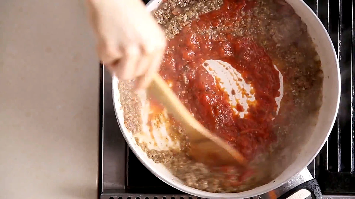 Chunky mushroom marinara cooking down in a pan