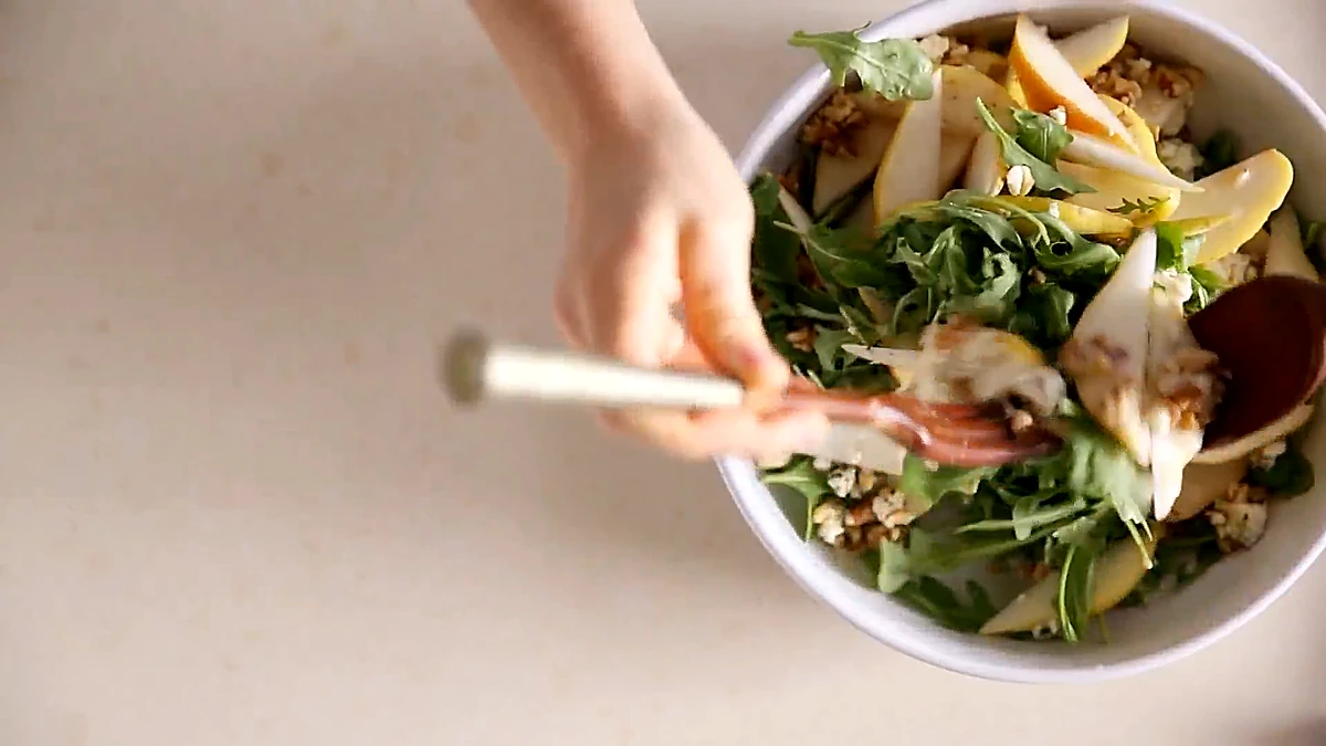 Overhead view of the pear arugula salad with walnuts and blue cheese