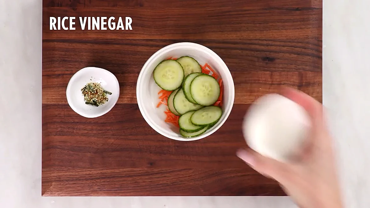 Rice vinegar added to cucumber and carrots
