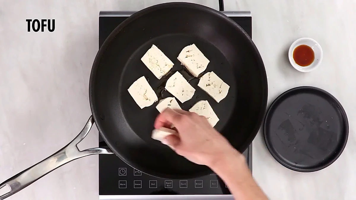 Tofu pieces placed in the skillet