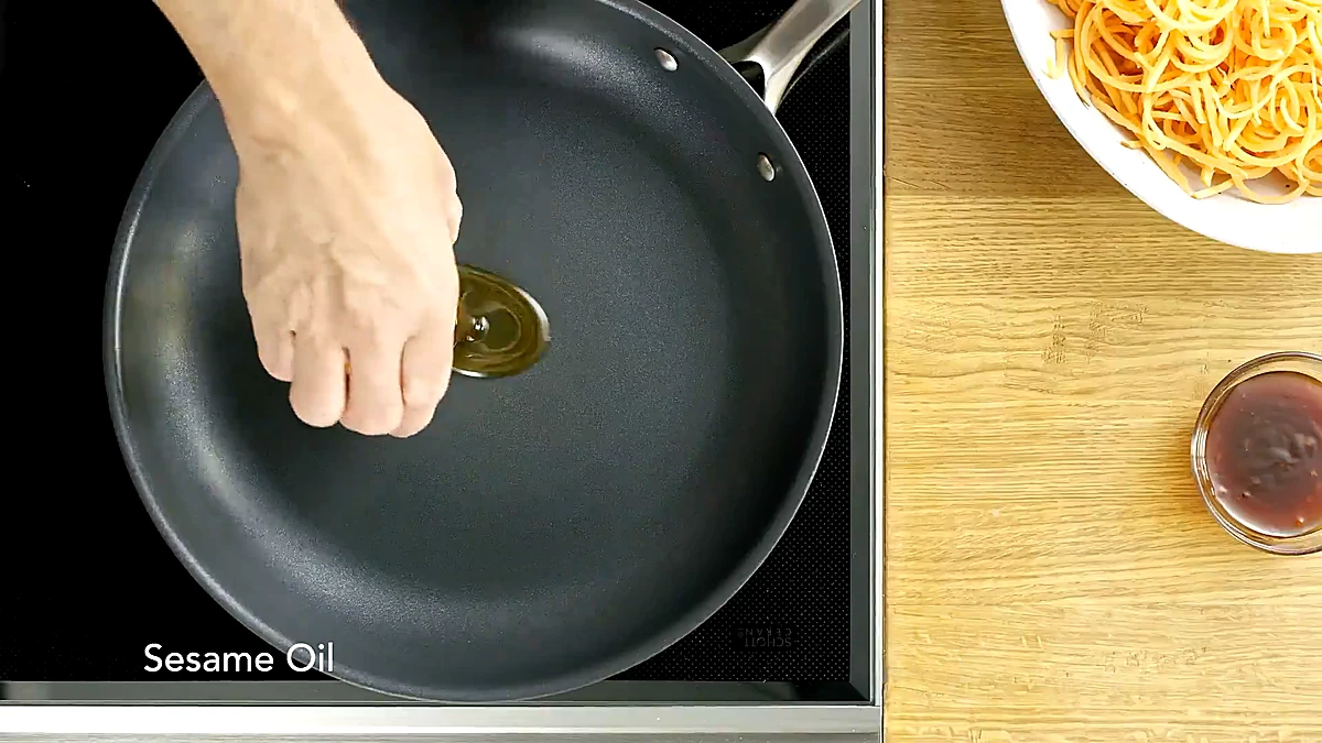 Sesame oil poured into a skillet