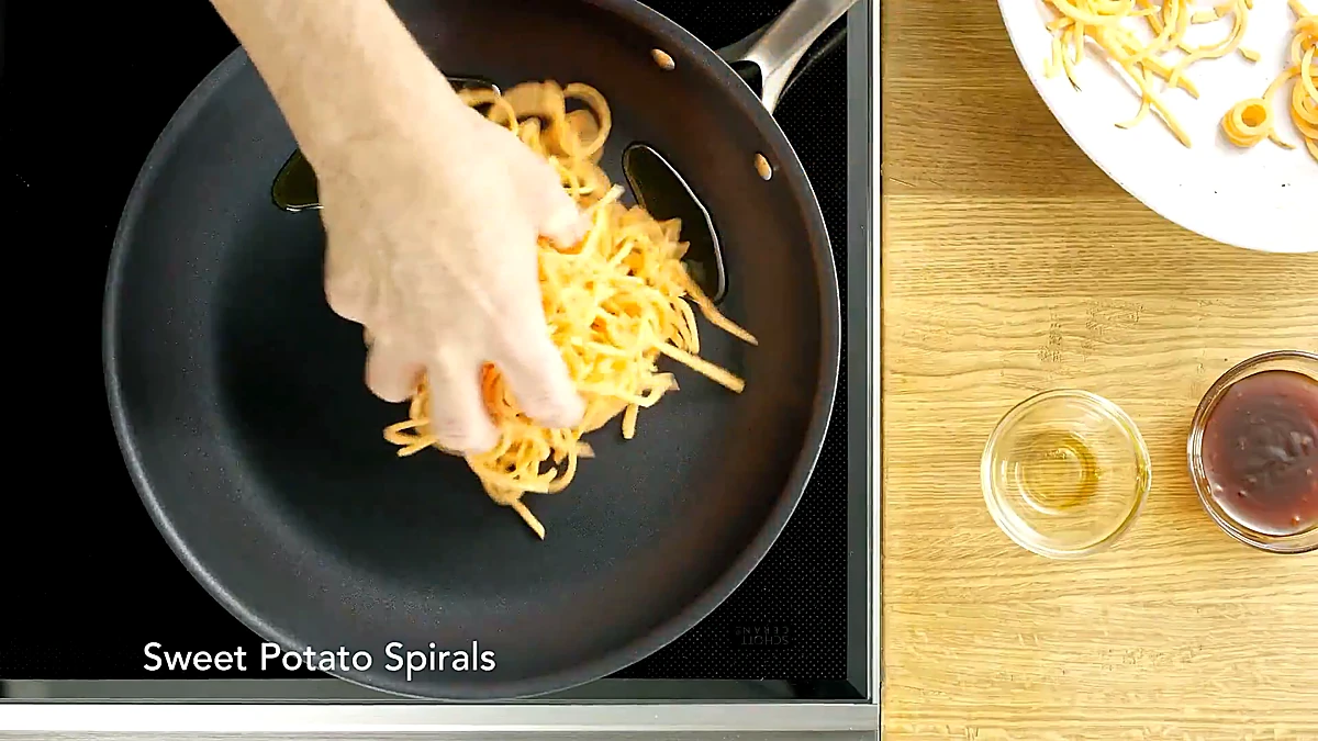 Sweet potato spirals added to skillet
