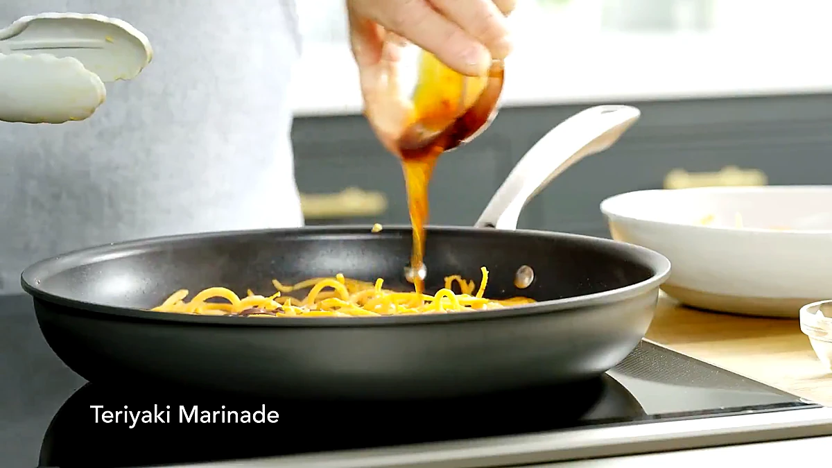 Teriyaki marinade poured over sweet potato spirals