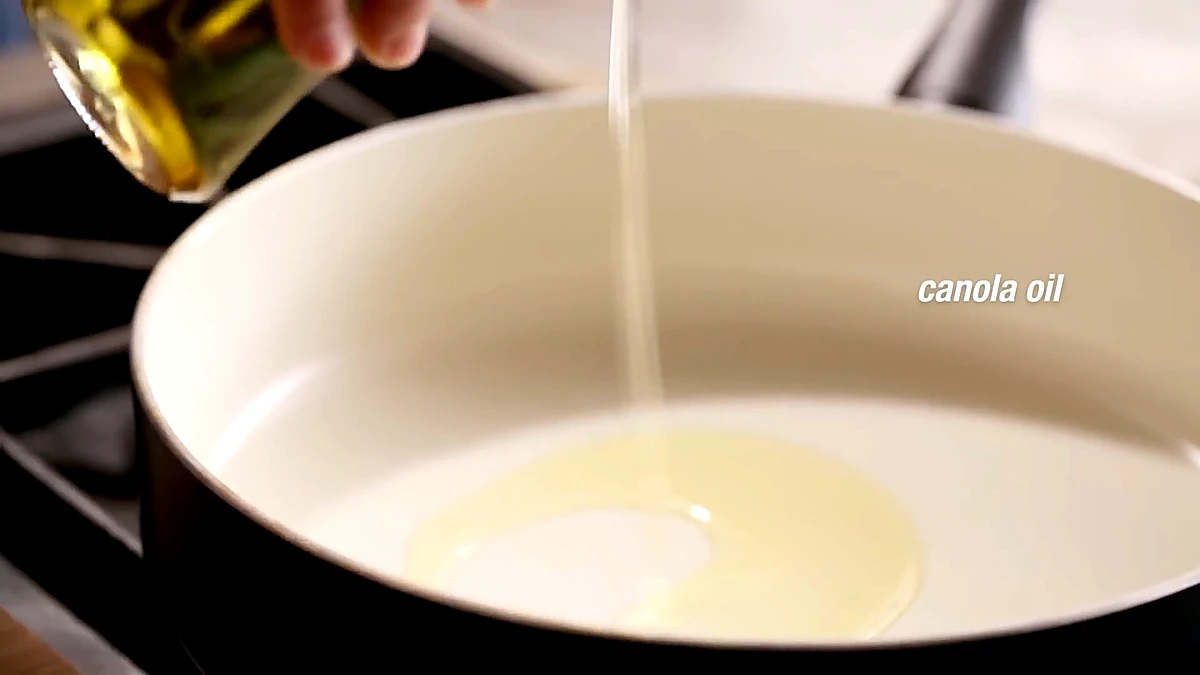 Canola oil poured into a skillet