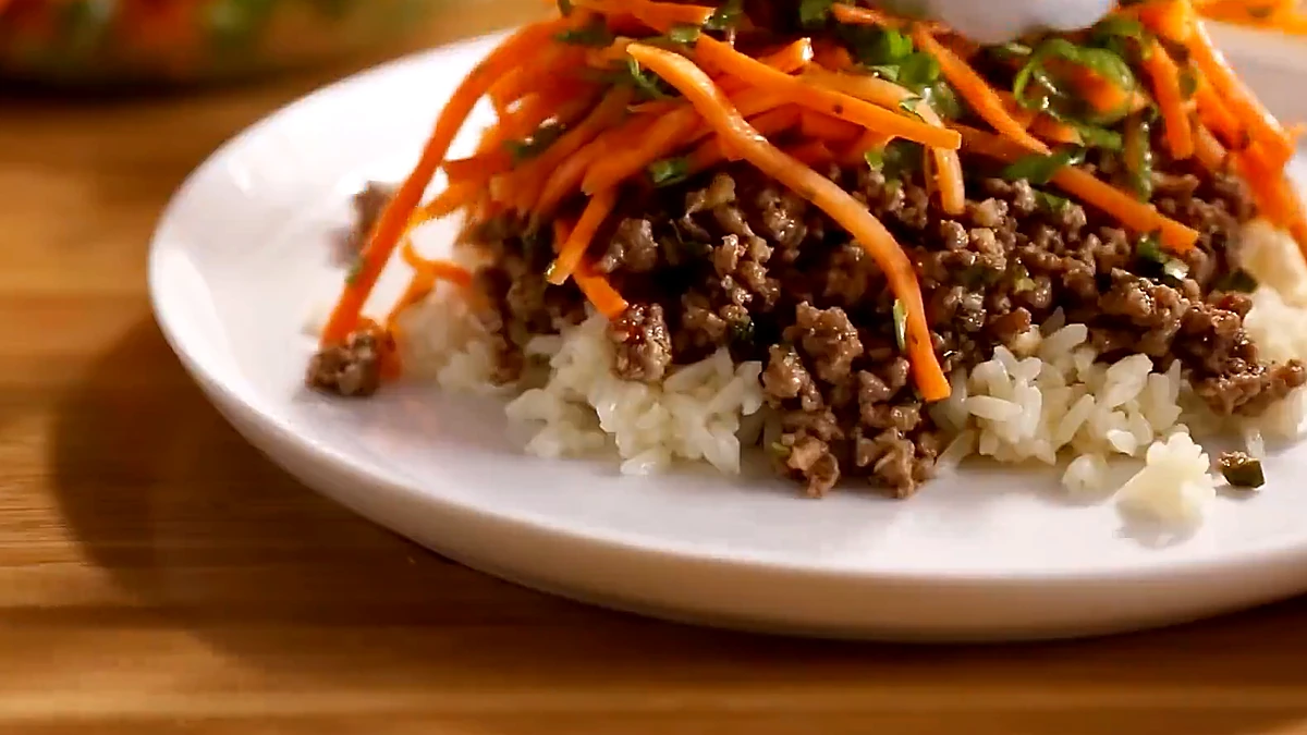Thai beef carrot basil salad served with chopsticks