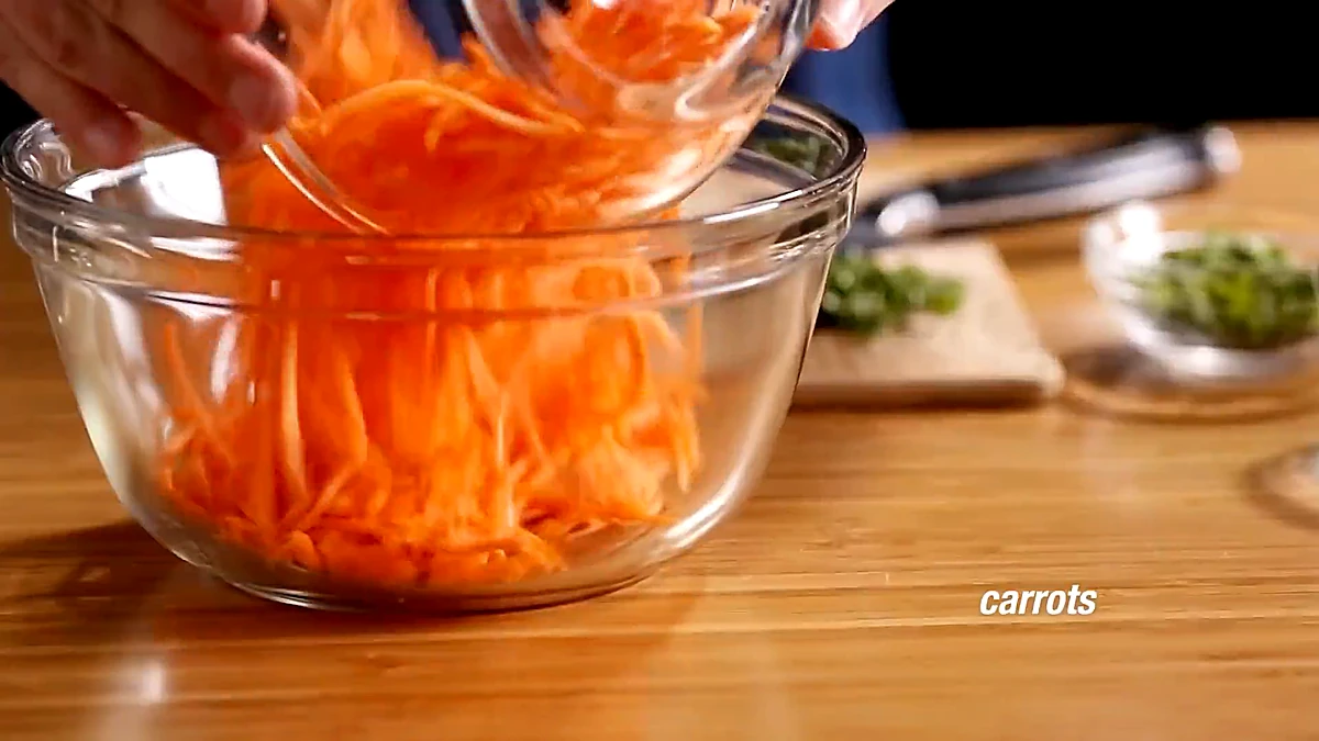 Matchstick carrots added to the bowl