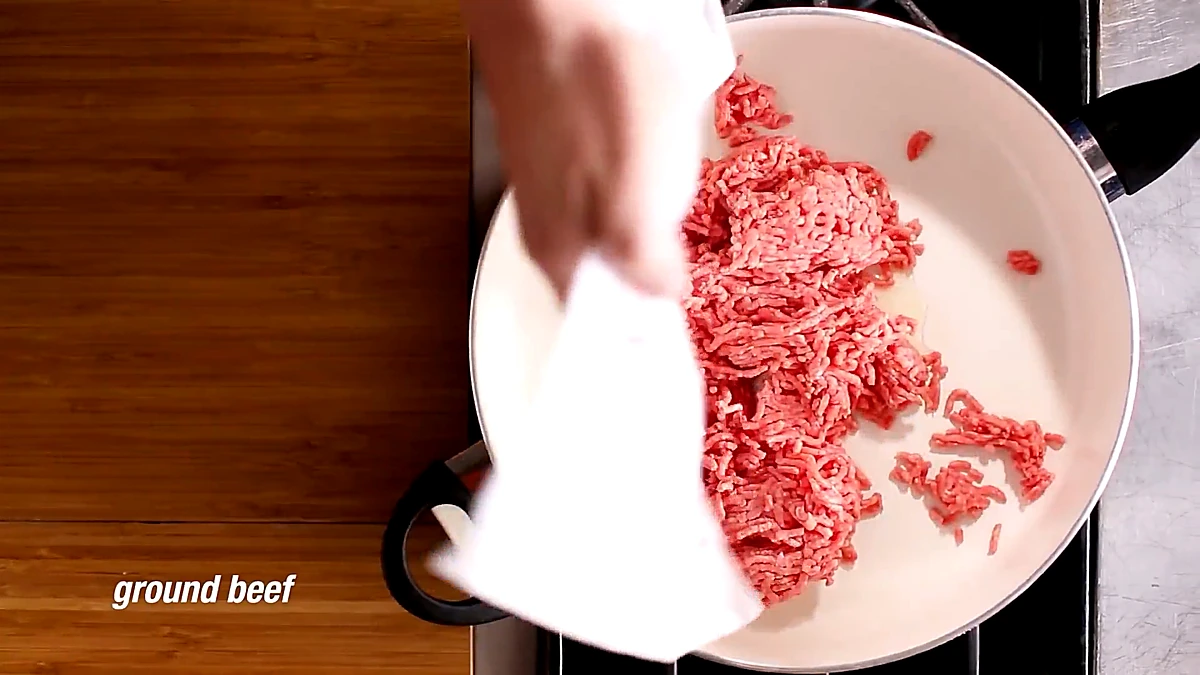 Ground beef added to the skillet