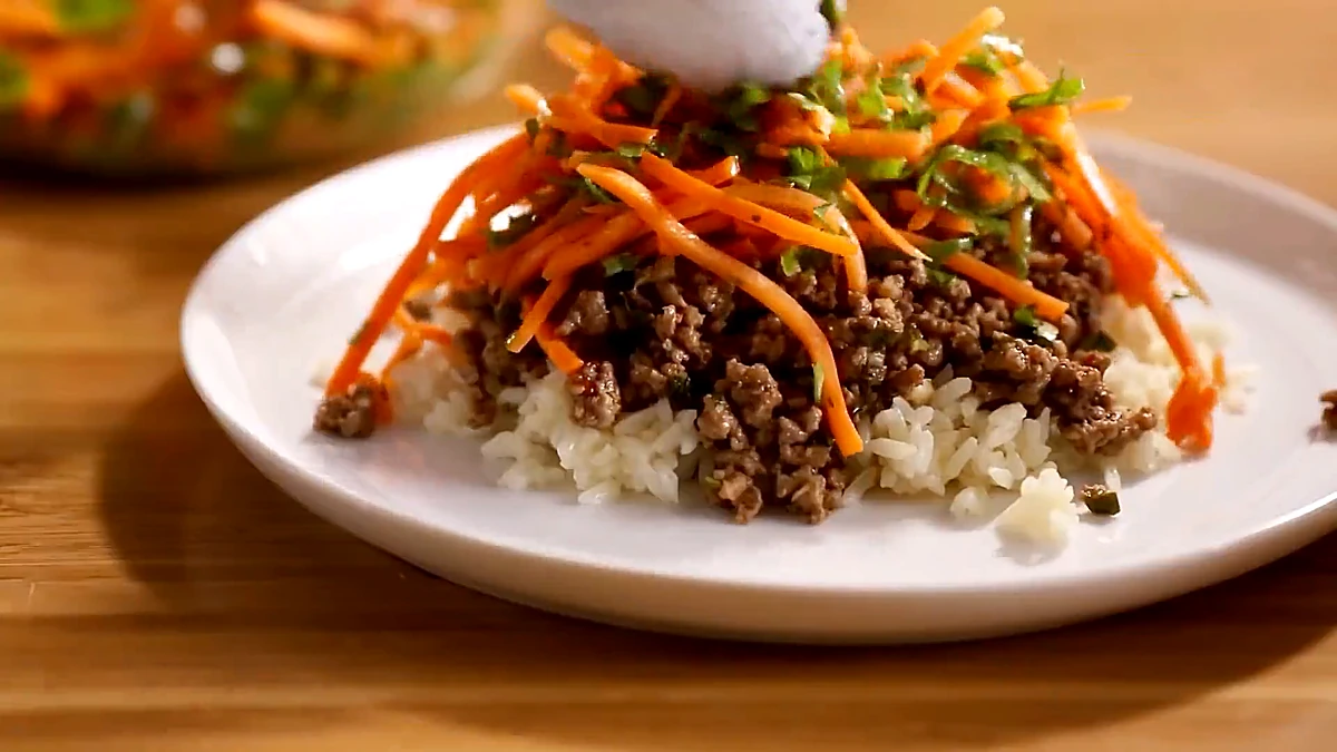 Carrot basil salad added over Thai beef and rice